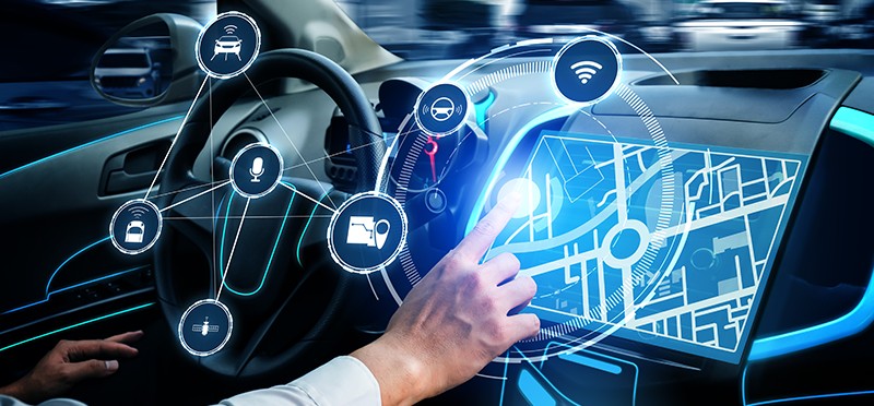 A steering wheel and car dashboard overlayed with a digital image of icons.